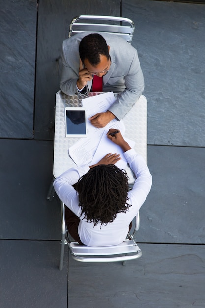 Two people discussing facing each other